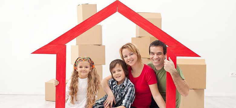 A happy family moving boxes